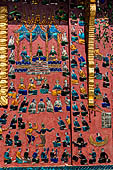 Wat Xieng Thong temple in Luang Prabang, Laos. the Ho Tai, the library. Colourful glass mosaics on a pink background with scenes of daily life. 